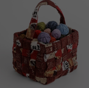 Värikkäitä lankakeriä virkkaamalla toteutetussa korissa.